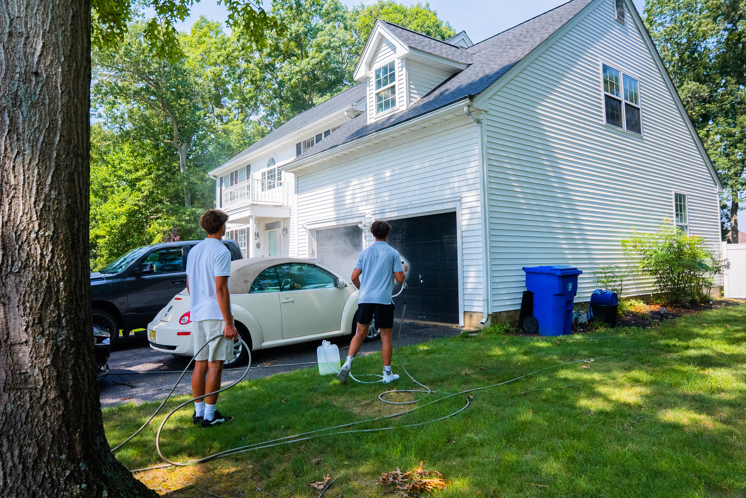 All Pro technicians washing a garage and driveway